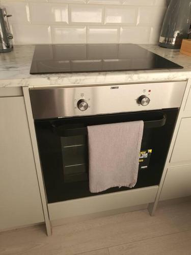 a kitchen with a stove with a towel on it at Awave From It All - Escape the city life in Jaywick Sands