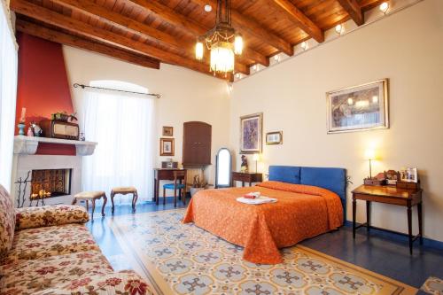 a bedroom with a bed and a couch and a table at VinsLounge Suite in Barletta