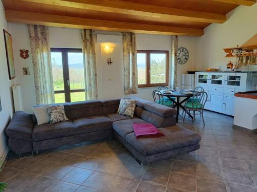 a living room with a couch and a table at House in Istria in Plomin