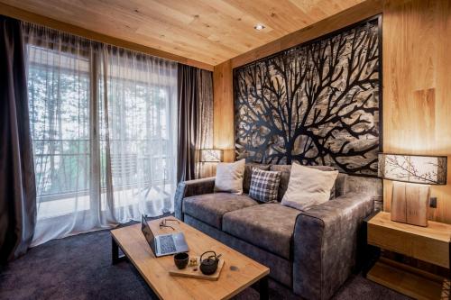 a living room with a couch and a table at Kashmir Wellness & SPA Hotel Adults Only in Velingrad