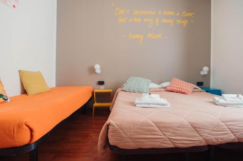 duas camas num quarto com uma citação na parede em Ostello Bello Milano Centrale em Milão