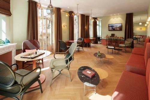 a living room with chairs and tables and a couch at Hotel De Cambis Best Western Premier Collection in Avignon