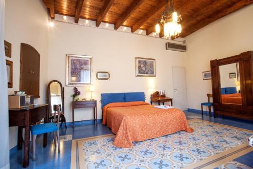 a bedroom with a bed and a desk and a mirror at VinsLounge Suite in Barletta