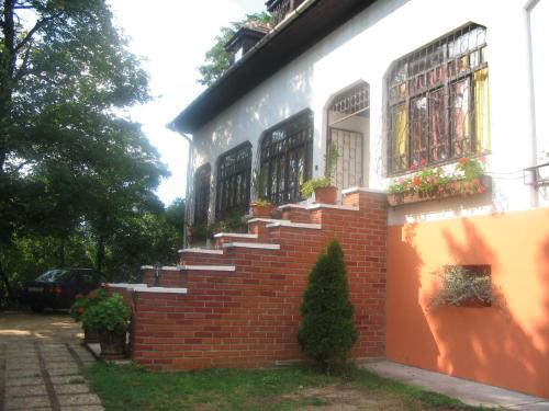 a brick building with stairs on the side of it at Krisztina Panzió in Balatonalmádi