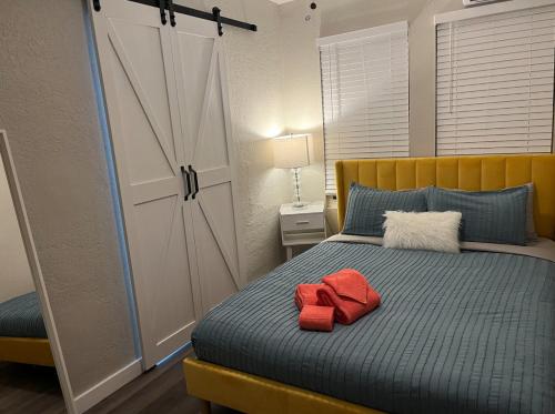 a bedroom with a bed with red towels on it at The Blue Wave Suite Unit C in St. Petersburg