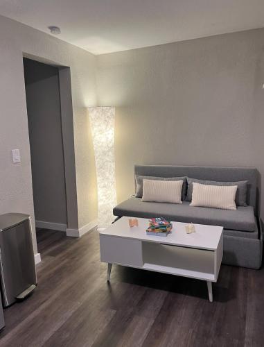 a living room with a couch and a coffee table at The Blue Wave Suite Unit C in St. Petersburg