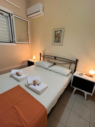 a bedroom with two beds with towels on them at Lydia’s house in Argostoli