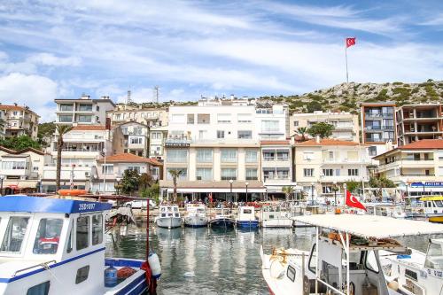 a group of boats docked in a harbor with buildings at Ufuk Otel in Cesme