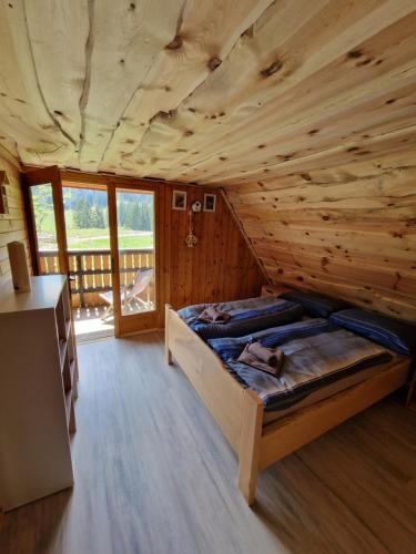 a bedroom with a bed in a log cabin at OTO`S CABIN in Radovljica