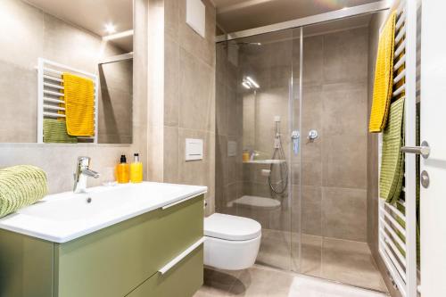 a bathroom with a toilet and a sink and a shower at Mali Apartments Balcony in Tirolo