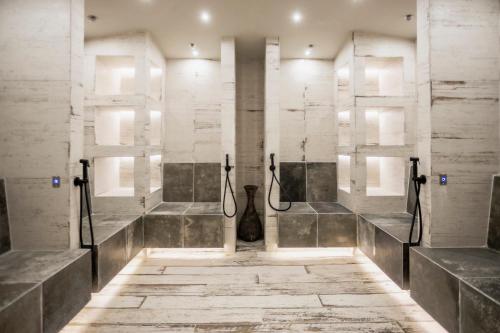 a bathroom with a shower with concrete walls at Kashmir Wellness & SPA Hotel Adults Only in Velingrad