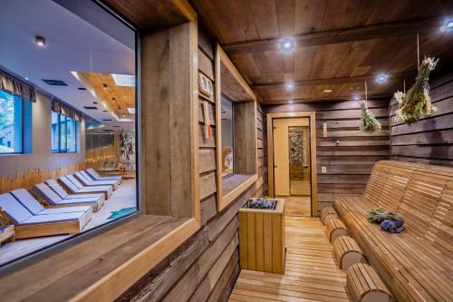 a sauna with wooden walls and wooden benches at Kashmir Wellness & SPA Hotel Adults Only in Velingrad