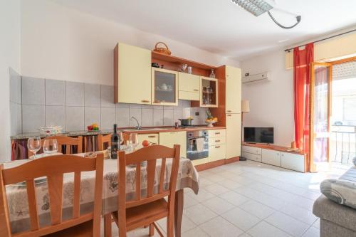 a kitchen and dining room with a table and chairs at AffittaSardegna - Casa Merisi in Alghero