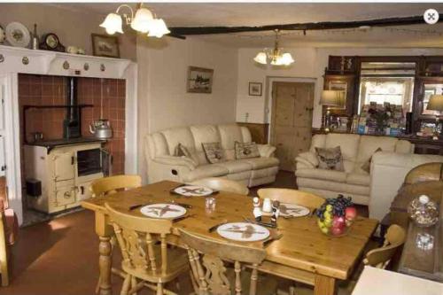 a living room with a wooden table and chairs at Charming 3-Bed House on Exmoor in Minehead