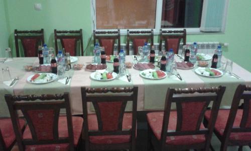 a long table with plates of food on it at Family Hotel Panorama in Sarnitsa