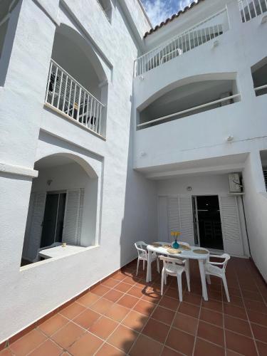 a patio of a house with a table and chairs at APCOSTAS - Complejo Al Andalus in Alcossebre