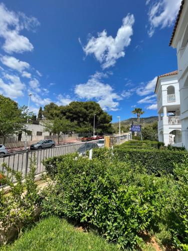 a view of a building and a street with bushes at APCOSTAS - Complejo Al Andalus in Alcossebre