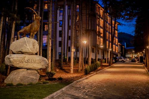 a statue of a giraffe sitting on top of a rock at Kashmir Wellness & SPA Hotel Adults Only in Velingrad