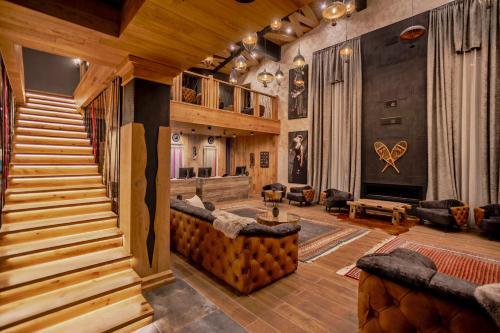 a living room with wooden stairs and a stair case at Kashmir Wellness & SPA Hotel Adults Only in Velingrad