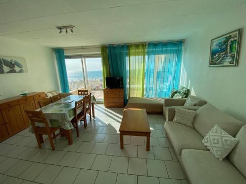 un salon avec un canapé et une table dans l'établissement Duplex T3 6 personnes avec terrasse, BBQ et parking, près de la plage - FR-1-81-496, au Barcarès