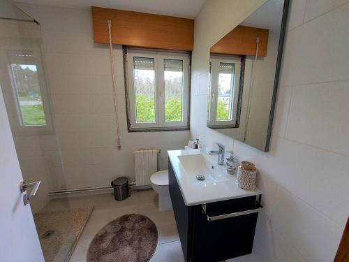a bathroom with a sink and a toilet at Casa Dabuela Costa da Morte in Muxia