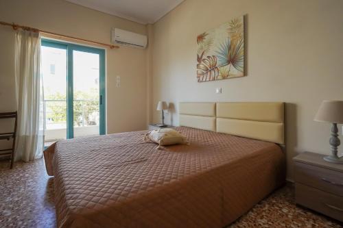 a bedroom with a bed with a pillow on it at Meltemi House in Mastichari