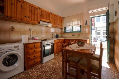 a kitchen with a washing machine and a washer at Meltemi House in Mastichari