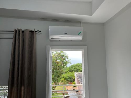 a room with a window and a fire alarm at Mandeville Vacation Home in Mandeville