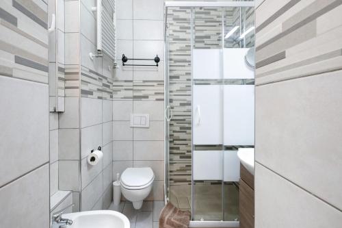 a small bathroom with a toilet and a shower at Argentina in Loano