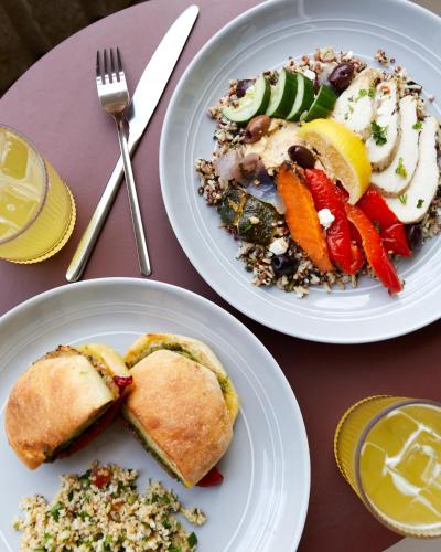two plates of food sitting on a table with food at Wayfinder Waikiki - Voted Top 10 Best Hotels in Hawaii! in Honolulu