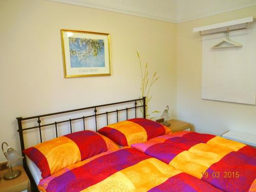 a bedroom with two beds with colorful blankets at Landhaus Wachau in Aggsbach