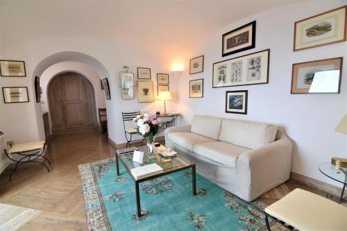 a living room with a couch and a table at Villa Castello Apartments in Capri