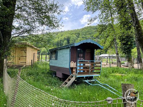 a small house in the middle of a field at Parc animalier du Hérisson in Doucier