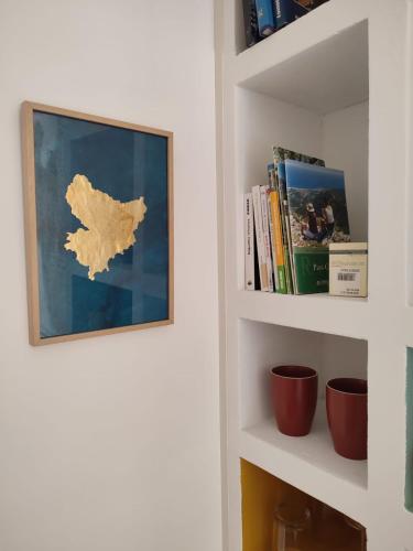 a book shelf with a picture of a map on it at Chambre d'hôtes Les Tomettes in Vence