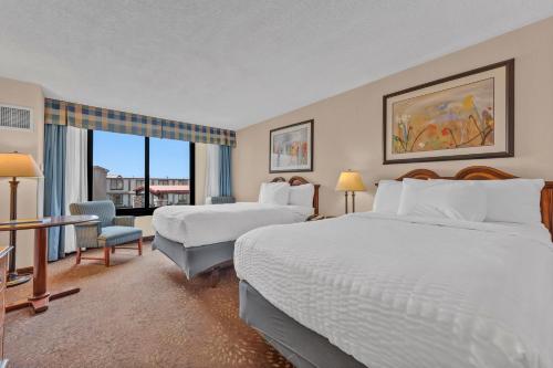 a hotel room with two beds and a window at Buffalo Airport Hotel in Cheektowaga