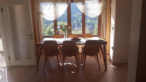 a dining room table with chairs and a large window at Harvel Villa - RESIDENCE FOR FAMILY ONLY - 6 BEDROOMS 