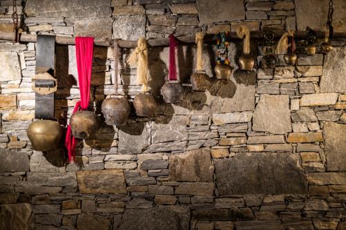 a wall with pots and utensils hanging on it at Kashmir Wellness & SPA Hotel Adults Only in Velingrad