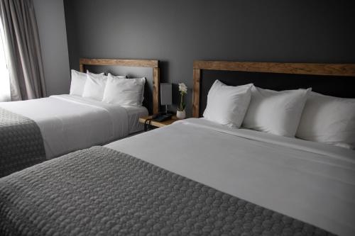 two beds sitting next to each other in a hotel room at Hôtel Napoléon in Angers
