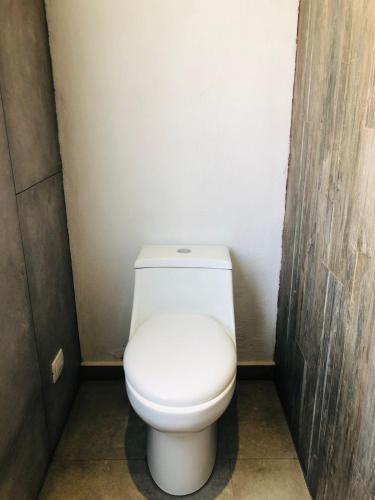 a bathroom with a white toilet in a stall at Casa la Noria in Parras de la Fuente