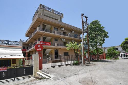 a building with a stop sign in front of it at OYO Flagship Maira Residency in Dehradun