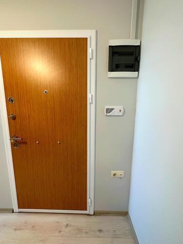 a door in a room with a microwave on the wall at ima Apartmanı in Trabzon