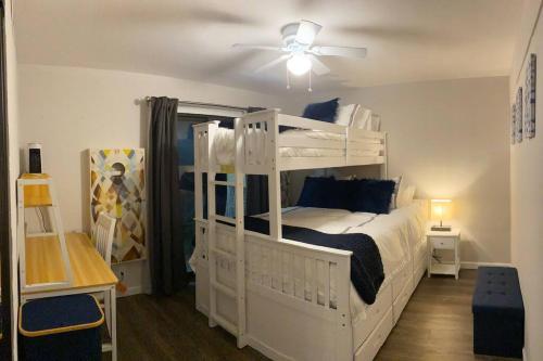 a bedroom with a white bunk bed with a ceiling fan at Relax @CercaDelPlaya: .7mi to the Beach! 4BR/2.5BA in San Diego