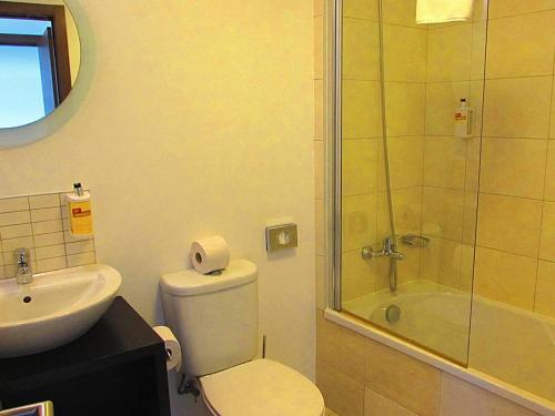 a bathroom with a shower and a toilet and a sink at Relaxing 2 Bed Apartment with pool view Sol Dunas in Prainha