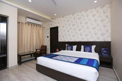 a bedroom with a large bed and a desk at Niharika Guest House in Guwahati