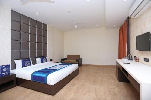 a hotel room with a bed and a desk at Niharika Guest House in Guwahati