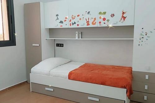 a small bedroom with a bed and a cabinet at Moderne appartement meublé (avec Wifi) in Fès