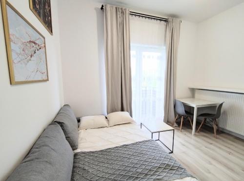 a living room with a couch and a table at White Studio in Wieliczka