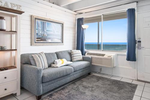 a living room with a couch and a window at Fontainebleau Terrace in Panama City Beach