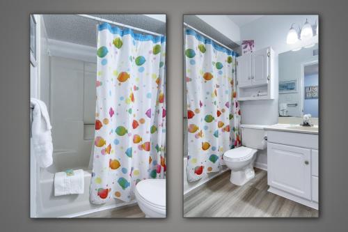 a bathroom with a toilet and a shower curtain at Gulf Shores Plantation Condos in Gulf Shores