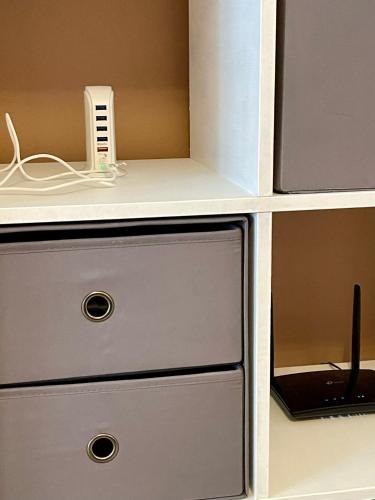 a white counter with a drawer with a phone on it at Appartamento Chagall in Asti
